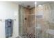Walk-in shower with glass enclosure and pebble flooring at 501 S Ocean Blvd. # 304, North Myrtle Beach, SC 29582