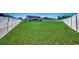 Large backyard with artificial turf and white fence at 575 Mossbank Loop, Longs, SC 29568