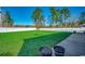 Spacious backyard with artificial turf and white vinyl fence at 575 Mossbank Loop, Longs, SC 29568