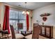 Charming dining area with glass table and wicker chairs at 575 Mossbank Loop, Longs, SC 29568