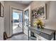Bright and airy entryway with a console table and framed artwork at 575 Mossbank Loop, Longs, SC 29568