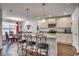 Island kitchen with granite counters, white cabinets, and breakfast bar at 575 Mossbank Loop, Longs, SC 29568