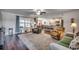 Spacious living room with hardwood floors, comfortable seating, and large windows at 575 Mossbank Loop, Longs, SC 29568