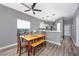 Bright dining room with wooden table and bench, adjacent to the kitchen at 612 River Oaks Dr. # 55-C, Myrtle Beach, SC 29579