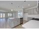 Open-concept kitchen with stainless appliances, island, and views of the living area and backyard at 616 St. Albans Loop, Conway, SC 29526