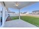 Covered back patio with a fan and an expansive lawn at 808 St. Albans Loop, Conway, SC 29526