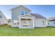 A backyard featuring a covered patio and lush green grass at 808 St. Albans Loop, Conway, SC 29526