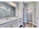 Bathroom with double vanity, white cabinets, and access to walk in closet and shower at 808 St. Albans Loop, Conway, SC 29526