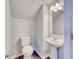 Cozy powder room with pedestal sink and dark wood flooring at 808 St. Albans Loop, Conway, SC 29526