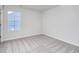 A bedroom with neutral walls, carpet, and a large window at 808 St. Albans Loop, Conway, SC 29526