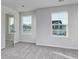 Bright bedroom showcasing two windows and neutral carpeting at 808 St. Albans Loop, Conway, SC 29526