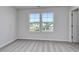 A bedroom with neutral walls, carpet, and two windows at 808 St. Albans Loop, Conway, SC 29526