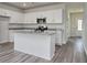 Modern kitchen featuring white cabinets, stainless steel appliances, and a granite-topped center island at 808 St. Albans Loop, Conway, SC 29526