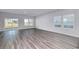 Bright living room featuring wood flooring, a sliding glass door, and large windows at 808 St. Albans Loop, Conway, SC 29526
