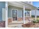 Inviting front porch with brick accents and ample natural light streaming through the windows at 808 St. Albans Loop, Conway, SC 29526