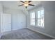 Bright bedroom with ceiling fan, grey carpet, and double doors at 8091 Laurel Ash Ave., Myrtle Beach, SC 29572