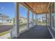 Spacious front porch with wooden ceiling and white columns overlooking the neighborhood at 8091 Laurel Ash Ave., Myrtle Beach, SC 29572