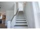 Wooden staircase with white railings leading to upper level at 8091 Laurel Ash Ave., Myrtle Beach, SC 29572