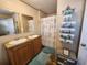 Bathroom with double vanity, shower, and linen storage at 818 Wayne St., North Myrtle Beach, SC 29582