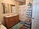 Bathroom with double vanity, shower, and linen storage at 818 Wayne St., North Myrtle Beach, SC 29582