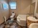 Bathroom with toilet, corner tub, and double vanity at 818 Wayne St., North Myrtle Beach, SC 29582
