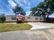 Tan mobile home with deck, red umbrella, and landscaped yard at 818 Wayne St., North Myrtle Beach, SC 29582