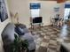 Living room with gray couch, TV, and dining area at 818 Wayne St., North Myrtle Beach, SC 29582
