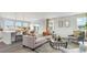 Open living room with kitchen island seating and neutral decor at 834 Ireland Dr., Longs, SC 29568