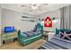 Bedroom with twin beds, beach decor, and ceiling fan at 9520 Shore Dr. # 3B, Myrtle Beach, SC 29572