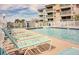 Community pool with multiple lounge chairs at 9520 Shore Dr. # 3B, Myrtle Beach, SC 29572