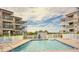 Community pool with lounge chairs and surrounding buildings at 9520 Shore Dr. # 3B, Myrtle Beach, SC 29572
