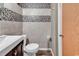 Modern bathroom featuring mosaic tile accents, wood-look flooring, and stylish fixtures at 1012 N Waccamaw Dr. # 203, Murrells Inlet, SC 29576