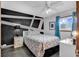 Bedroom featuring a modern accent wall, plush bedding, and a bright window view at 1012 N Waccamaw Dr. # 203, Murrells Inlet, SC 29576