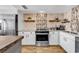Modern kitchen with stainless steel appliances, stylish tile backsplash, and ample counter space at 1012 N Waccamaw Dr. # 203, Murrells Inlet, SC 29576