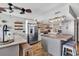 Spacious kitchen featuring stainless steel refrigerator, island with seating, and open layout at 1012 N Waccamaw Dr. # 203, Murrells Inlet, SC 29576