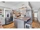 Bright kitchen with stainless steel refrigerator, island, and modern lighting fixture at 1012 N Waccamaw Dr. # 203, Murrells Inlet, SC 29576