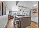 Open-concept kitchen with island, modern lighting, and ocean views from the adjacent living area at 1012 N Waccamaw Dr. # 203, Murrells Inlet, SC 29576