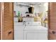 Functional laundry room with washer, dryer, shelving, and storage space at 1012 N Waccamaw Dr. # 203, Murrells Inlet, SC 29576