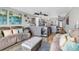 A living room with a view of the kitchen and access to the balcony at 1012 N Waccamaw Dr. # 203, Murrells Inlet, SC 29576