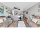 A living room with a view of the kitchen and access to the balcony at 1012 N Waccamaw Dr. # 203, Murrells Inlet, SC 29576
