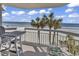 Balcony with ocean views, seating area, and a sunny space for relaxation at 1012 N Waccamaw Dr. # 204, Murrells Inlet, SC 29576