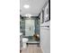 Modern bathroom with glass enclosed shower, neutral gray tile, and sleek fixtures at 1012 N Waccamaw Dr. # 204, Murrells Inlet, SC 29576
