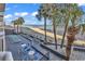 Relax on the deck with chairs and tables overlooking the ocean and sandy beach at 1012 N Waccamaw Dr. # 204, Murrells Inlet, SC 29576