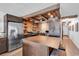 Modern kitchen with stainless steel appliances, island bar, and wood ceiling at 1012 N Waccamaw Dr. # 204, Murrells Inlet, SC 29576