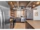 Well-equipped kitchen featuring stainless steel appliances, wood ceiling, and brick backsplash at 1012 N Waccamaw Dr. # 204, Murrells Inlet, SC 29576