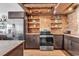 Well-equipped kitchen featuring stainless steel appliances, wood ceiling, and brick backsplash at 1012 N Waccamaw Dr. # 204, Murrells Inlet, SC 29576