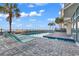 Outdoor pool area with lounge chairs, ocean view, and palm trees at 1012 N Waccamaw Dr. # 204, Murrells Inlet, SC 29576