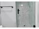 Glass-enclosed shower featuring sleek black fixtures and herringbone tile at 1012 N Waccamaw Dr. # 204, Murrells Inlet, SC 29576