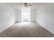Spacious bedroom featuring plush neutral carpet, ample natural light, and a ceiling fan at 104 Willow Ridge Rd., Myrtle Beach, SC 29588