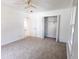 Cozy bedroom with neutral carpet, white walls, a ceiling fan, and ample closet space at 104 Willow Ridge Rd., Myrtle Beach, SC 29588